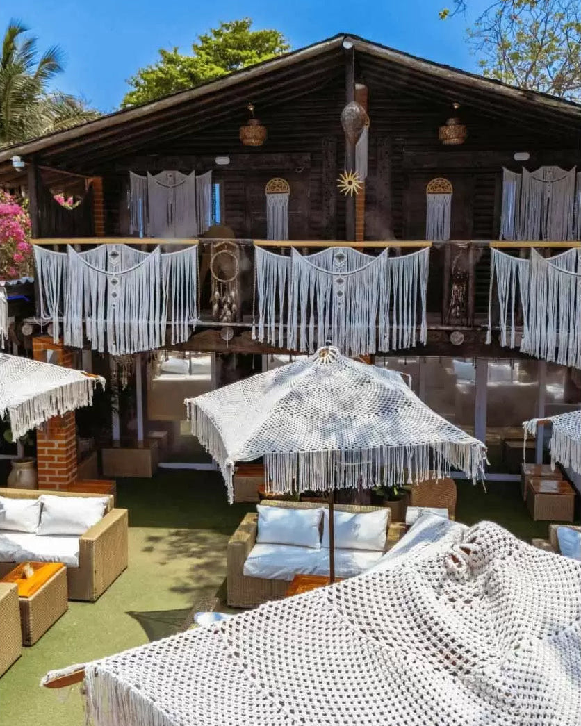 Outdoor patio with wooden deck, furniture, and decorative elements under a clear blue sky.